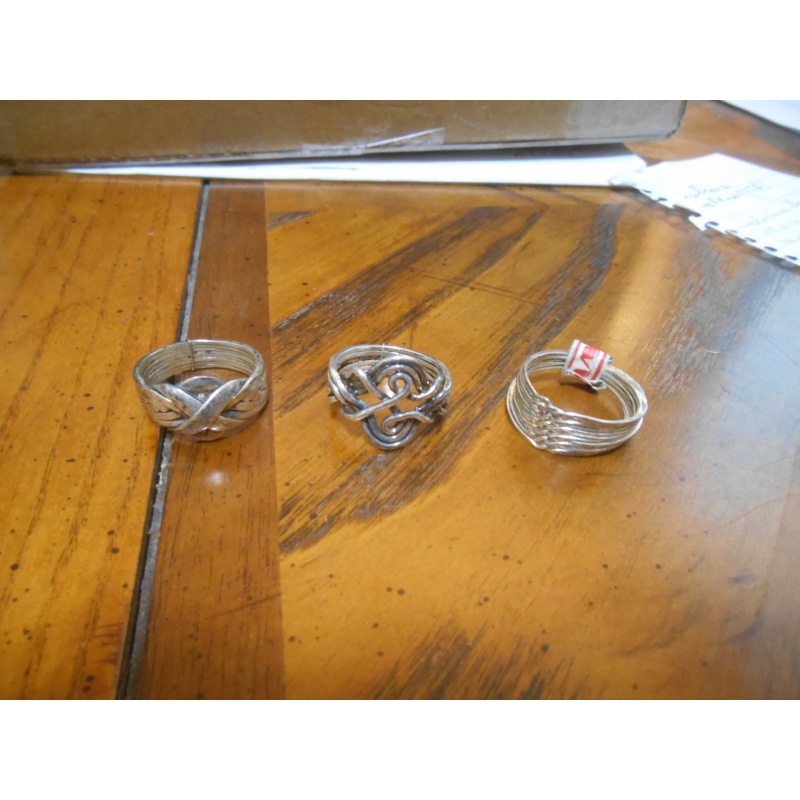 Four silver puzzle rings; 12, 8, 6, 3 bands