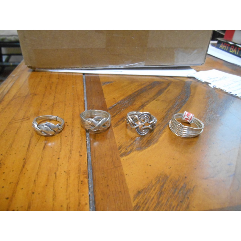 Four silver puzzle rings; 12, 8, 6, 3 bands