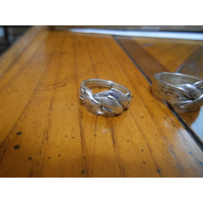 Four silver puzzle rings; 12, 8, 6, 3 bands